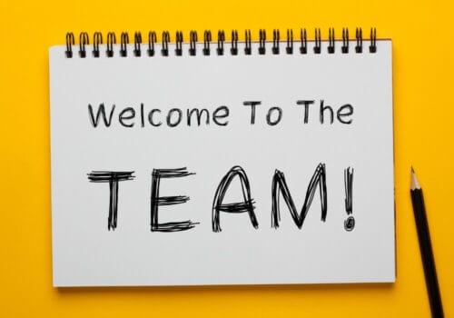 Open notebook with the words 'Welcome to the team!'